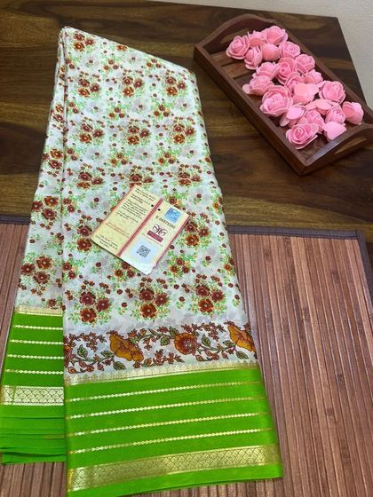 A delicate floral print Kalamkari Mysore silk saree with a contrasting green border.