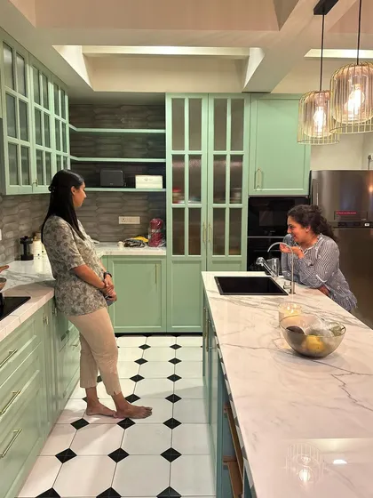 Kitchen confidential. A candid moment with a client in her newly completed kitchen. These conversations are essential to ensure every detail meets the family's needs.