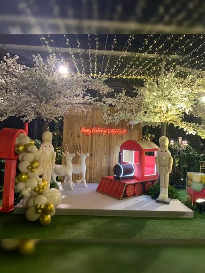 Make your birthday special with a unique theme. For this party, I created a magical Christmas-in-wonderland setup, complete with a toy train, reindeer, nutcrackers, and white cherry blossom trees.