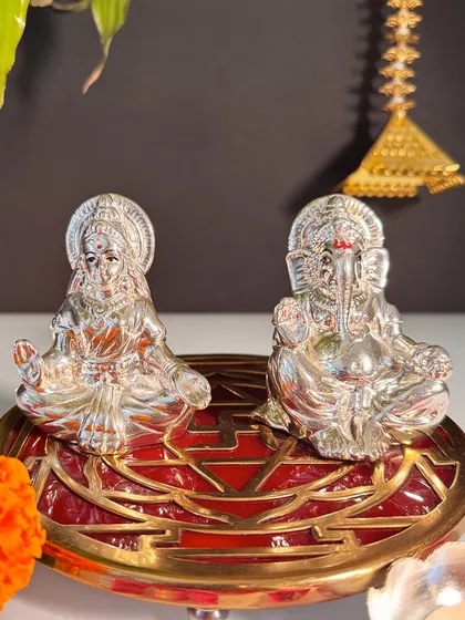 This compact silver-plated Lakshmi and Ganesha duo sits on an ornate red and gold base. It's a perfect, powerful set for a smaller altar, office desk, or as a meaningful housewarming gift.