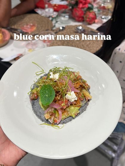 A tostada made with blue corn masa harina, topped with fresh ingredients. A modern take on a traditional Mexican street food.