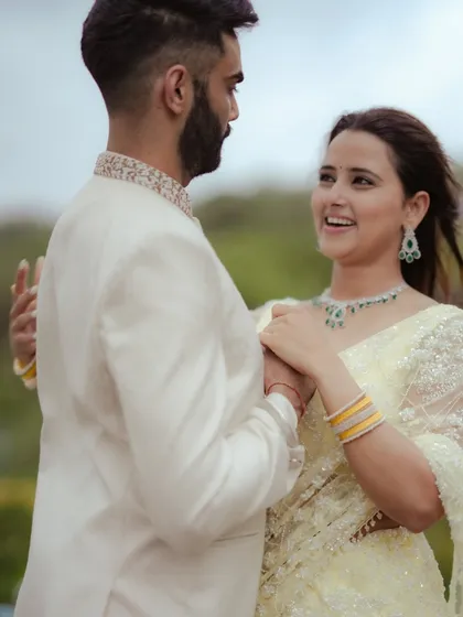 A candid moment of dance and movement during an engagement shoot in Mumbai. The natural light and the couple's interaction create a dynamic and romantic image that feels alive.