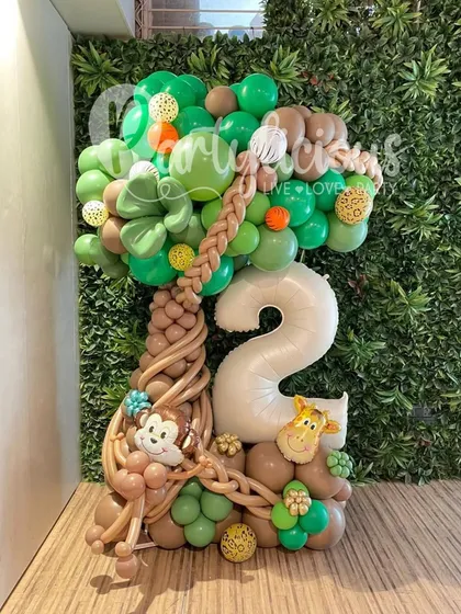 A closer look at our jungle-themed balloon artistry. This custom bouquet for a second birthday features a tree trunk made of twisted balloons, with playful monkeys and a giraffe, showing the intricate detail we put into our work.