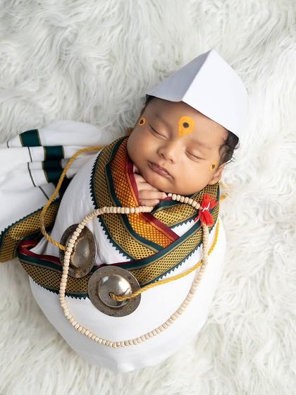 Another variation of the baby as a Warkari on a soft fur rug, combining traditional elements with classic newborn photography textures.