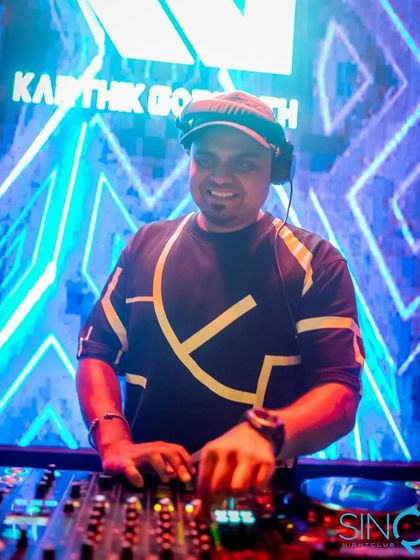 A cool shot of me at the decks in Goa, with my logo on the screen behind me.