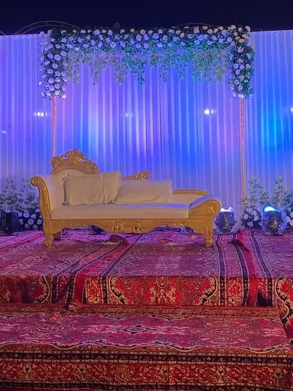 The Sangeet stage at night, with the blue lighting creating a cool and sophisticated party vibe.