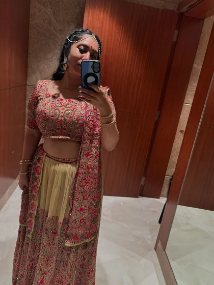 A mirror selfie showing off my full lehenga for a sangeet event. I believe dressing for the theme adds to the overall experience.
