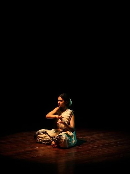 A seated pose in Bharatanatyam, showcasing the precision and control of the dance form.