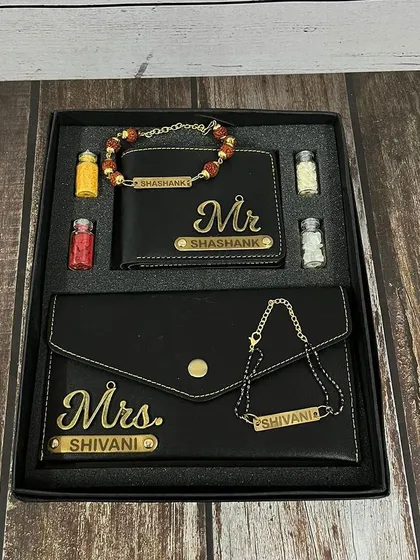 The bhai-bhabhi wallet and rakhi combo shown in a sleek black leather finish with "Mr." and "Mrs." charms.
