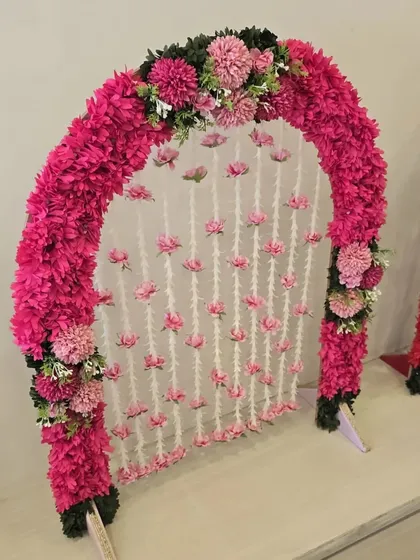 A sweet and simple all-pink floral arch, this piece is perfect for adding a touch of charm to your home celebration.
