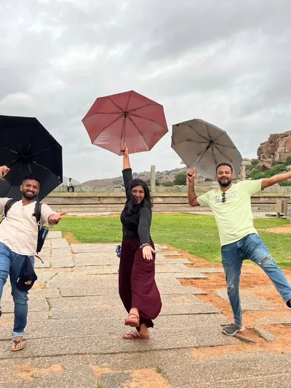 A playful "Singin' in the Rain" moment during a light shower in Hampi.
