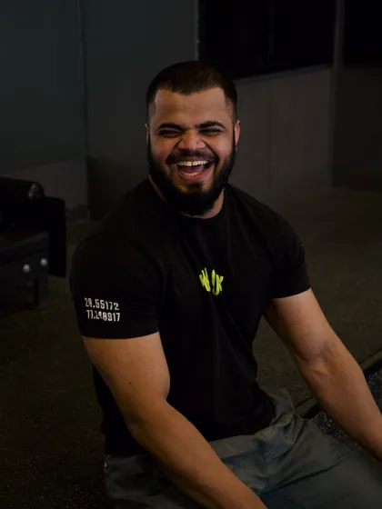 A candid shot of coach Vinay laughing during a session. His approachability and positive energy make even the toughest workouts enjoyable.
