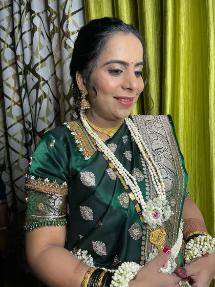 A side profile showing the elegant hairstyle and soft makeup.