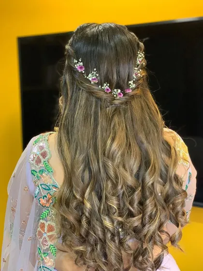 A detailed look at the floral half-up hairstyle, perfect for a Roka or engagement ceremony.
