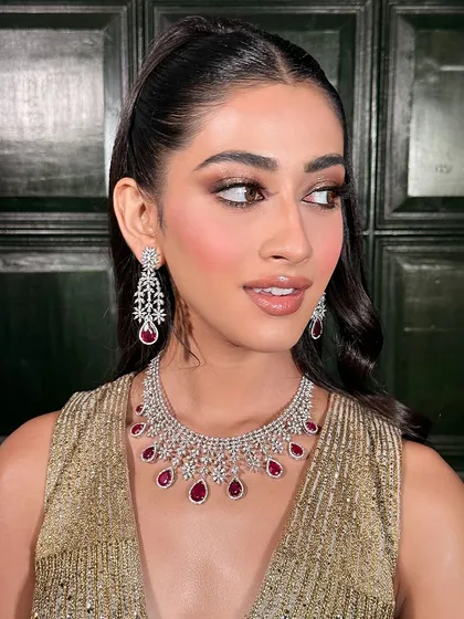 For the bride who loves glamour. This Sangeet or Cocktail look features a sharp, smokey eye, luminous skin, and a sleek high ponytail, creating a powerful and chic statement that’s ready for the dance floor.
