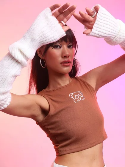 A soft girl take on K-pop style. I focused on accessories like these white arm warmers to complement the simple brown tank top, creating a look that’s both trendy and approachable.