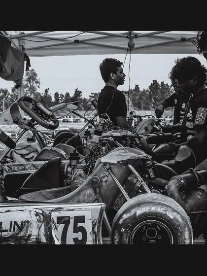 A black and white shot capturing the emotion and hard work of our technical team in the pits.