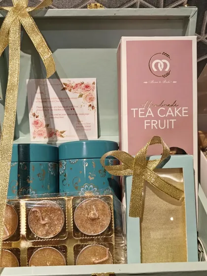 Another angle of our special edition Diwali trunk hamper, showcasing the arrangement of tea cake, tins, and glitter diyas.