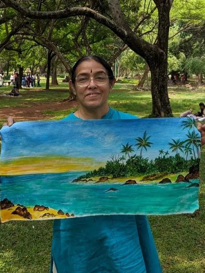 Holding up a finished seascape painting. Even in the park, we can travel to faraway places through our art.