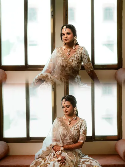 A beautiful portrait of the bride by the window, her white and gold lehenga looking ethereal in the natural light.