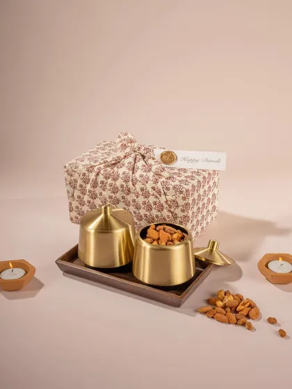 A minimalist and elegant shot for Doro Packaging's festive gift set. The clean background, soft lighting, and beautiful fabric wrap create a premium and sophisticated look for the brand.