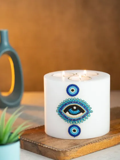 I designed this multi-wick evil eye candle to be a beautiful statement piece for your home. Made with clean-burning soy wax and adorned with a hand-beaded evil eye design, it's meant to bring positive vibes and a touch of style.