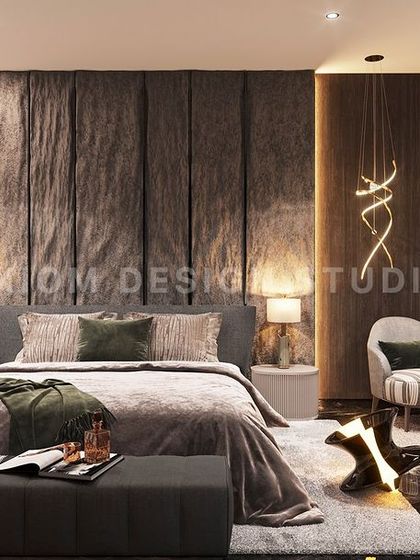 This modern luxury bedroom exudes bold character, with a dramatic textured stone bed back, a comfortable seating nook, and statement art.