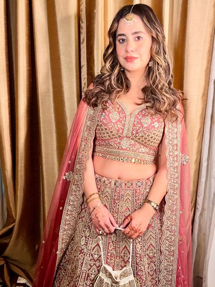 A confident and happy guest, looking beautiful in her embellished lehenga.