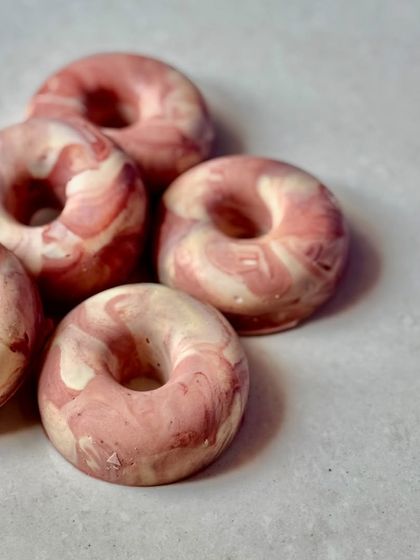 A pile of our Sweet Rose donut soaps. They are always plant-based and handmade with love, just like our traditional bars.