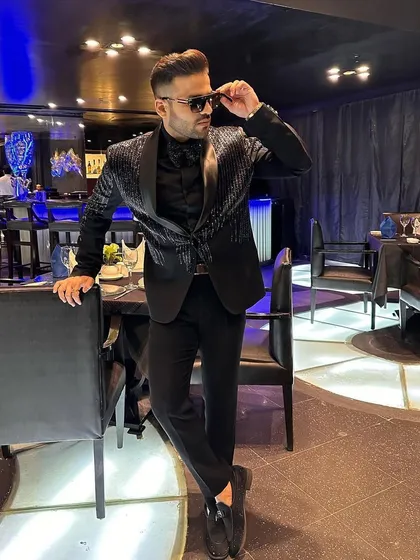 Our client strikes a pose in his striped sequin tuxedo, looking confident and ready for a night out.
