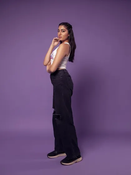 A full-length side profile. This is a great way to show the fit of the ripped jeans.