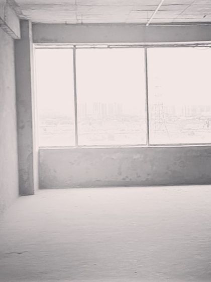 The large window in this future office provides ample natural light and a view of the city, which will be a central element in our design.