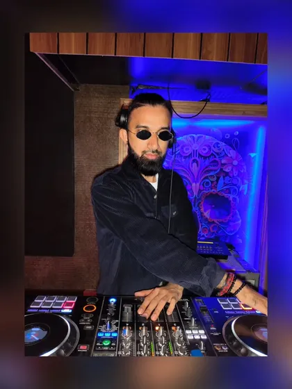 In the zone at the DJ booth. The right lighting and atmosphere in the booth help me create the perfect vibe for the crowd.