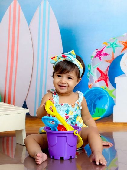 Ready to build a sandcastle. This little one is playing with her bucket and spade in our fun, indoor beach setup.