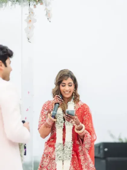 The bride reads her vows to the groom, her expression a mix of love and happy tears. This emotional moment during the ceremony is the heart of their wedding story.