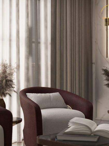 A close-up shot of an accent chair in a luxurious living room. The focus is on the rich textures of the fabric, the elegant brass details, and the pampas grass decor, all coming together to create a corner of pure sophistication.