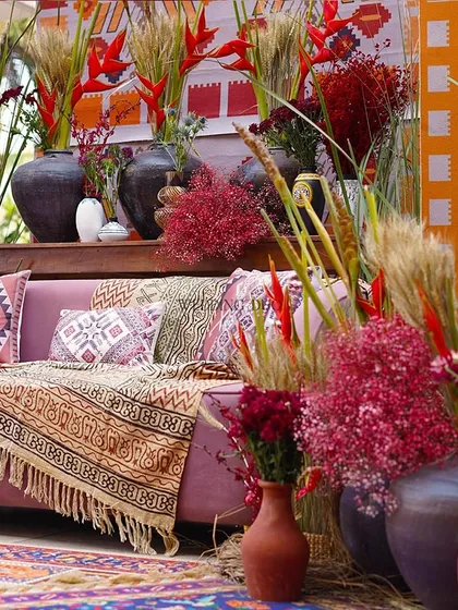 A cozy, boho-inspired Mehendi corner wrapped in color and culture. We layered tribal prints, terracotta vases, and wild florals in pinks and reds to create a space for laughter and warm conversations.