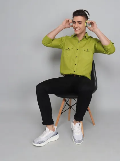 A lifestyle model shot showing a man enjoying music while wearing the product. This helps create a narrative and connects the clothing to a specific lifestyle or activity.