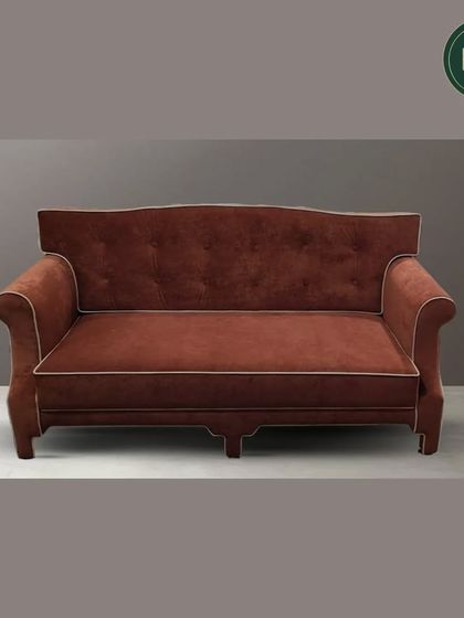 A full view of the terracotta-colored classic sofa, showcasing its elegant silhouette and button-tufted back. This is a statement piece that brings warmth and classic charm to a room.