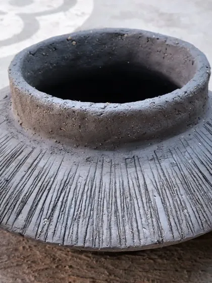 This textured pot, before firing, is a beautiful example of form and surface decoration. The lines will catch the glaze and smoke in interesting ways.
