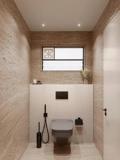 The toilet area in the travertine powder room concept. The design maintains its minimalist and cohesive aesthetic with wall-mounted fixtures and a continuation of the textured wall paneling.