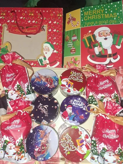 A collection of Secret Santa gifts going out. This includes festive tins filled with chocolates and matching gift bags.