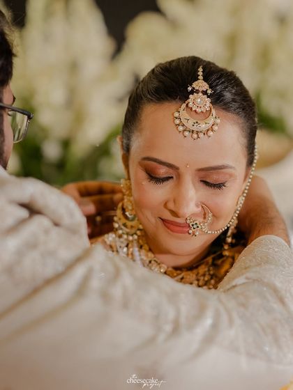 A tender moment between the bride and groom during their Gujarati wedding ceremony.