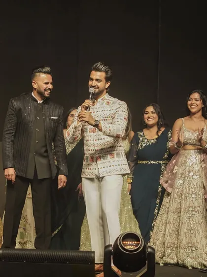 On stage with the happy couple and their family, sharing a laugh. These are the moments that build a connection and make the event feel personal and warm.
