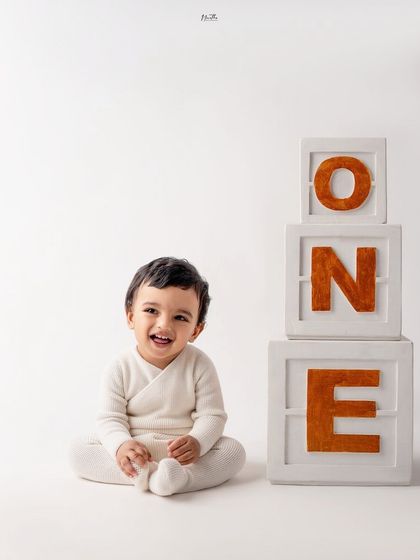 A simple and classic first birthday portrait with "ONE" blocks.