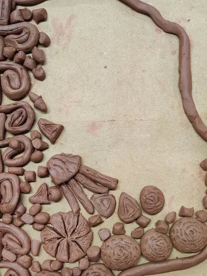 This abstract clay silhouette is filled with a variety of shapes and textures. It's a fantastic exploration of form and composition.
