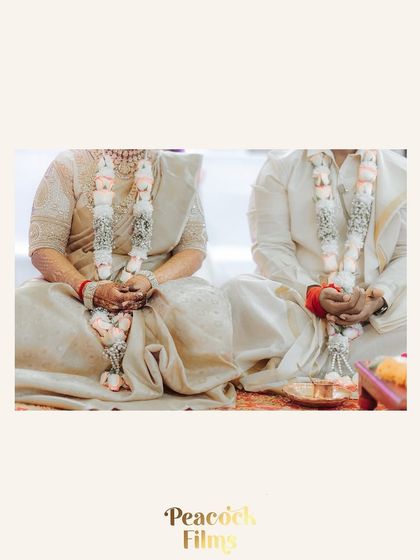 A detail shot of the couple's hands during a South Indian wedding puja, symbolizing their unity in tradition and faith.