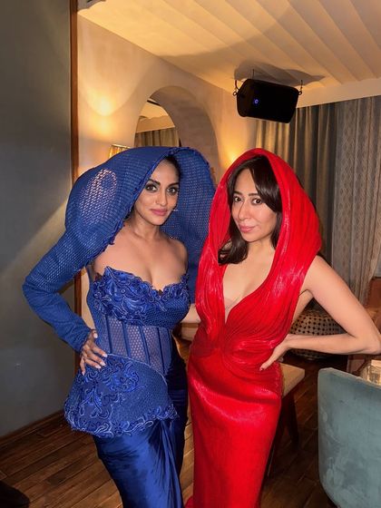 Two clients in my hooded gowns, one in Active Blue and one in red, giving high fashion with a twist of fantasy.