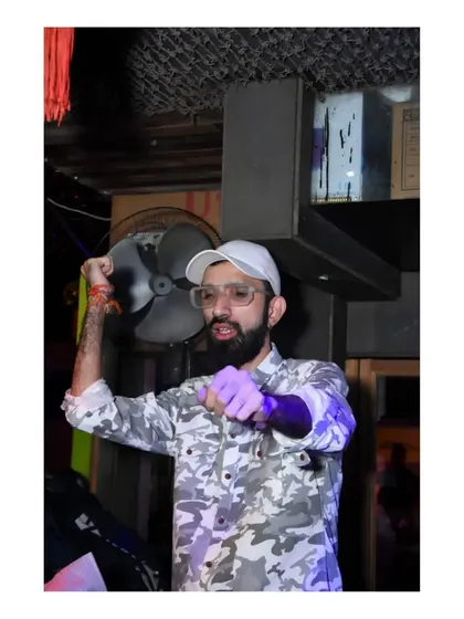 A high-energy pose, pointing at the crowd. I make sure to engage with everyone and make them feel like part of the show.