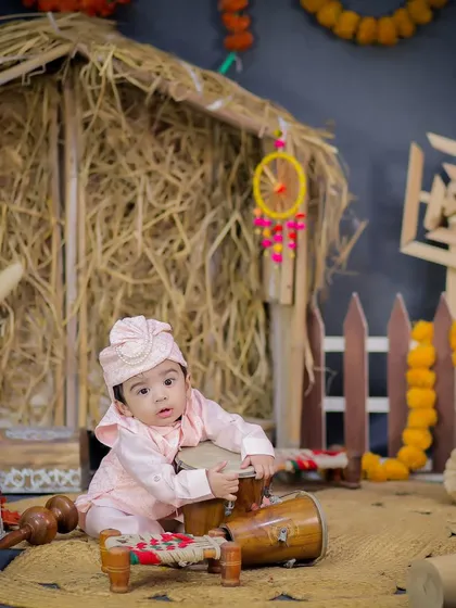 This little one is having fun with the dhol, creating a playful and candid moment during the Lohri photoshoot.